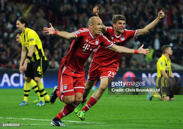 Arjen Robben of FC Bayern Muenchen celebrates scoring his side's second goal with team-mate Thomas Muller during the UEFA Champions League final...