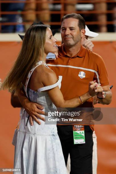 Golfer Sergio Garcia and his wife Angela Akins dance during a time out of the game between the Texas Longhorns and the Wyoming Cowboys at Darrell K...