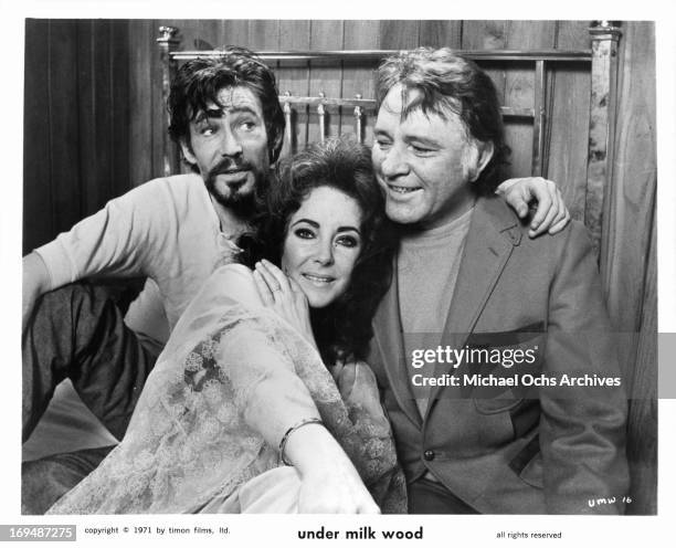 Peter O'Toole, Elizabeth Taylor and Richard Burton crowd on a bed during a break from shooting the film 'Under Milk Wood', 1972.