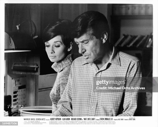 Audrey Hepburn looks over the shoulder of Efrem Zimbalist Jr in a scene from the film 'Wait Until Dark', 1967.