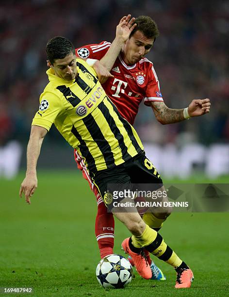 Borussia Dortmund's Polish striker Robert Lewandowski vies with Bayern Munich's Croatian striker Mario Mandzukic during the UEFA Champions League...