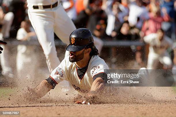 Angel Pagen of the San Francisco Giants slides in to home plate for a walk-off inside-the-park home run to beat the Colorado Rockies in ten innings...