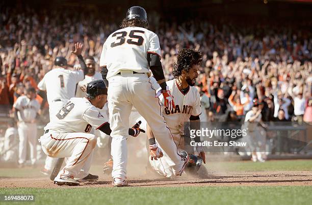 Angel Pagen of the San Francisco Giants reacts after he slide in to home plate for a walk-off inside-the-park home run to beat the Colorado Rockies...