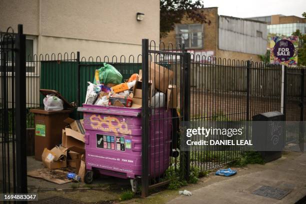 Piles of uncollected waste and bags of rubbish are pictured in the borough of Tower Hamlets, east London on September 28, 2023. Earlier this week,...