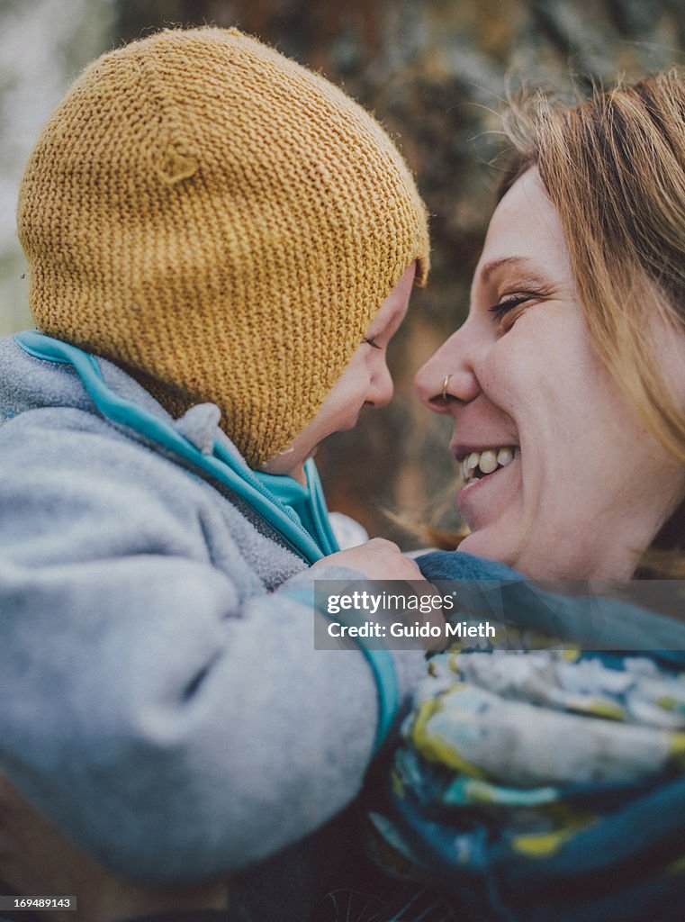 Happy mother with her baby boy outdoor