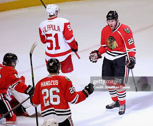 Bryan Bickell of the Chicago Blackhawks celebtrates his first period goal with Patrick Kane and Michal Handzus against the Detroit Red Wings in Game...