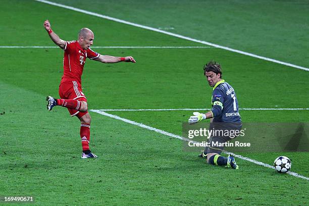 Arjen Robben of Bayern Muenchen scores their second goal past Roman Weidenfeller of Borussia Dortmund during the UEFA Champions League final match...