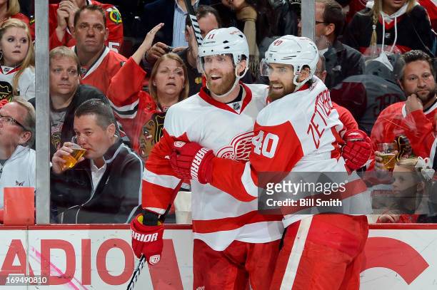 Daniel Cleary of the Detroit Red Wings celebrates with teammate Henrik Zetterberg after scoring against the Chicago Blackhawks in the second period...