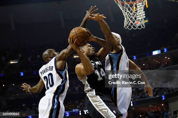 Gary Neal of the San Antonio Spurs goes up for a shot between Quincy Pondexter and Jerryd Bayless of the Memphis Grizzlies in the first half during...