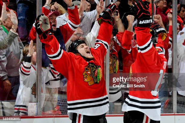 Andrew Shaw of the Chicago Blackhawks celebrates with teammate Jonathan Toews after scoring against the Detroit Red Wings in the second period in...
