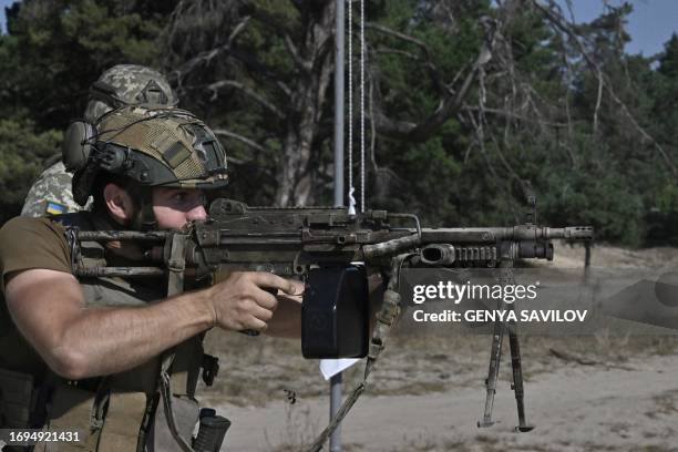 Ukrainian serviceman fires a M249 machinegun during training exercise in Kyiv region on September 27 amid the Russian invasion of Ukraine.