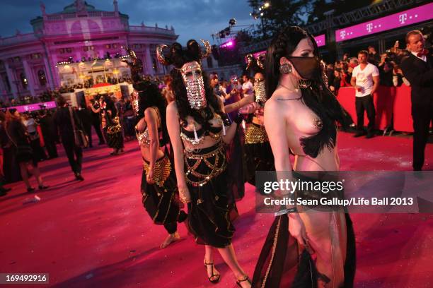 Guests, dressed with fancy costumes attend the 'Life Ball 2013 - Magenta Carpet Arrivals' at City Hall on May 25, 2013 in Vienna, Austria.