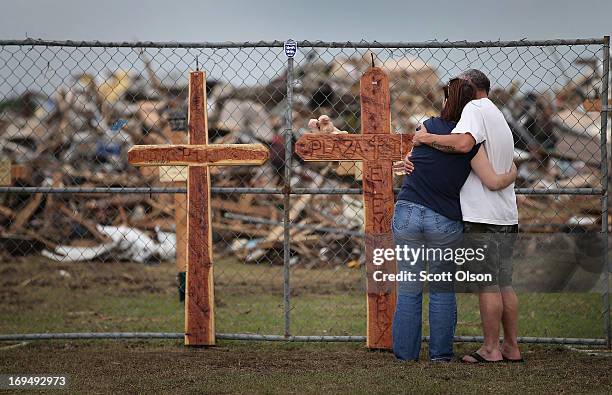 Deana Sanderson and Timothy Gansman embrace as they view a memorial in front of the destroyed Plaza Towers Elementary School where seven children...