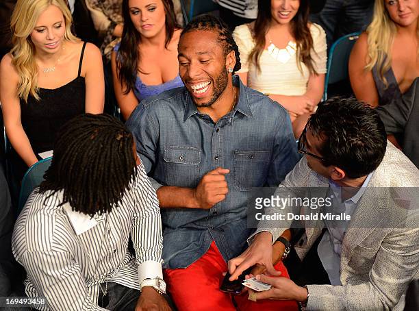 Professional football player Larry Fitzgerald of the Arizona Cardinals and professional poker player Antonio Esfandiari in attendance during UFC 160...
