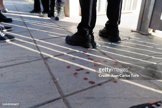 Drops of blood appear on the pavement outside a school where a stabbing incident occurred earlier in the morning on September 28, 2023 in Jerez de la...