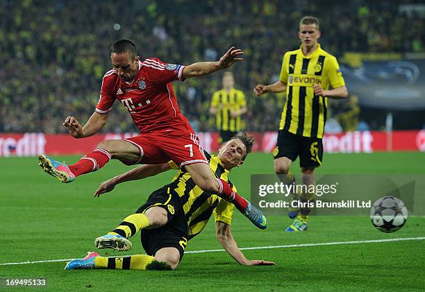 Lukasz Piszczek of Borussia Dortmund tackles Franck Ribery of FC Bayern Muenchen during the UEFA Champions League final match between Borussia...