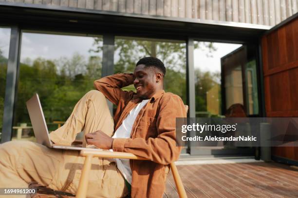 working remotely from the log cabin on the riverbank - porch stock pictures, royalty-free photos & images
