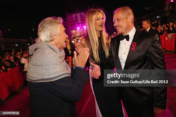 Model Tereza Maxova, jazz guitarist John McLaughlin and Gery Keszler arrive on the Magenta Carpet at the 2013 Life Ball at City Hall on May 25, 2013...