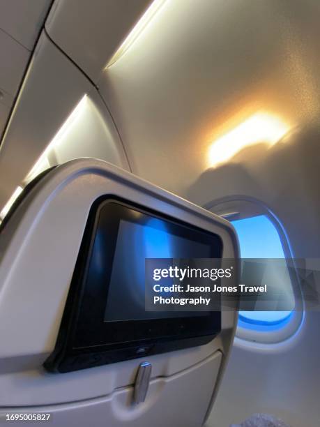 passenger point of view of a screen and window on a plane - namibia airplane stock pictures, royalty-free photos & images