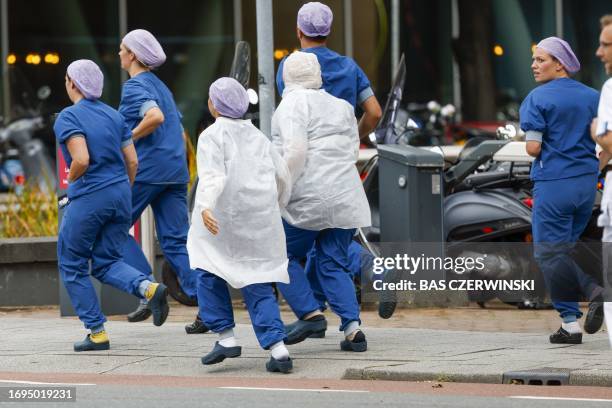Medical staff leave the Erasmus MC hospital that has been cordonned off following reports of a shooting, in Rotterdam, on September 28, 2023. Three...