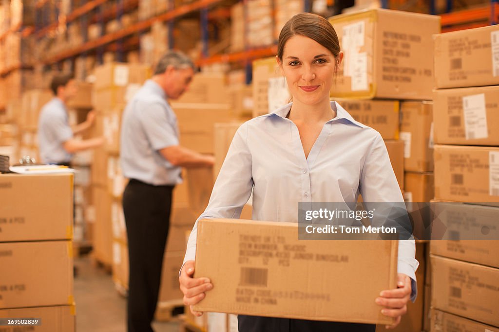 Workers packing boxes in warehouse