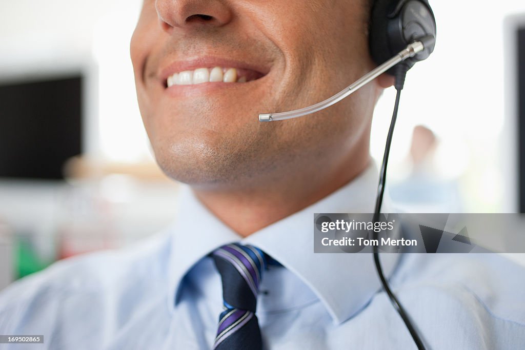 Businessman in headset working at desk