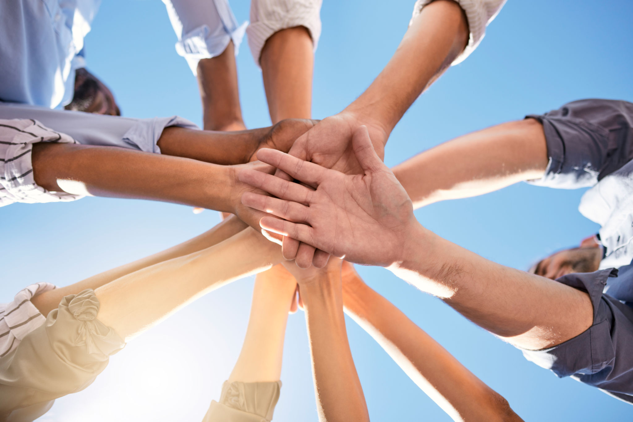 Low angle, hands and circle in success, solidarity or support team building, teamwork collaboration or diversity celebration. Men, women and friends in community huddle for business motivation goals Low angle, hands and circle in success, solidarity or support team building, teamwork collaboration or diversity celebration. Men, women and friends in community huddle for business motivation goals