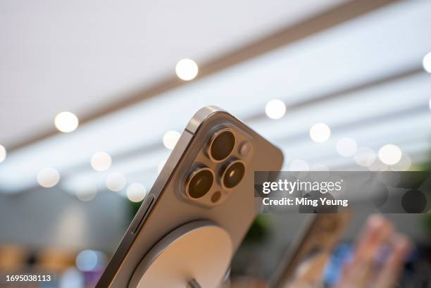 The iPhone 15 Pro Max in natural titanium seen from below with it's distinct 3 camera profile on display in store on September 22, 2023 in Milan,...