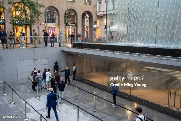 Customers queue outside the Apple Store in Milan ahead of the iPhone 15 launch on September 22, 2023 in Milan, Italy. After Apple's announcement of...