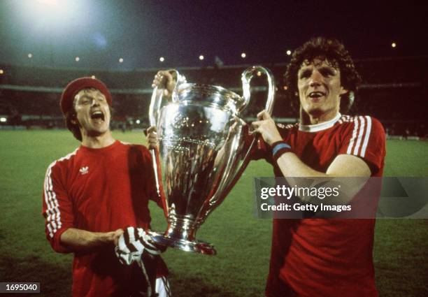 Kenny Swain and Allan Evans of Aston Villa lift the cup up after the European Cup Final between Bayern Munich and Aston Villa held on May 26, 1982 at...