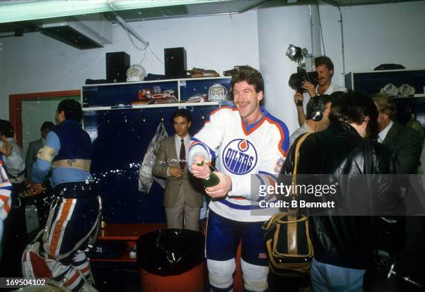 Glenn Anderson of the Edmonton Oilers celebrates with champagne in the locker room after the Oilers defeated the Philadelphia Flyers in Game 5 of the...