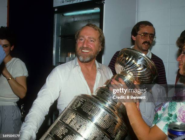 Owner Peter Pocklington of the Edmonton Oilers celebrates with the Stanley Cup Trophy in the locker room after the Oilers defeated the Philadelphia...