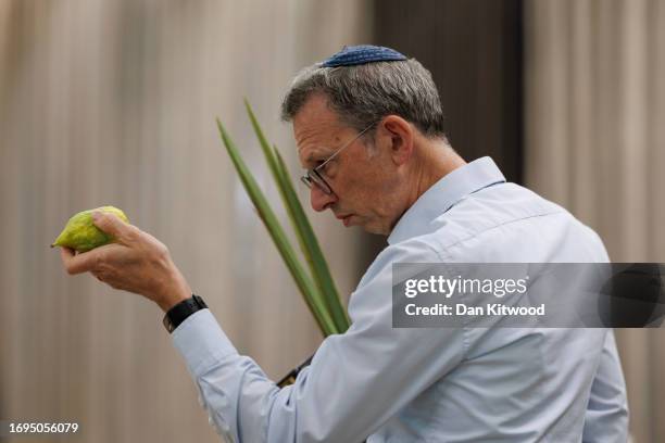 Members of the Jewish community inspect Esrogim, which make up one of the 'Four Species', or Arba Minim in Hebrew on September 21, 2023 in London,...