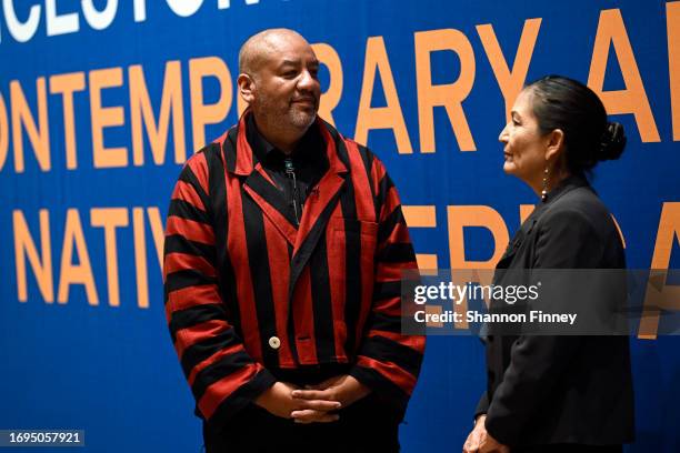 Artist Jeffrey Gibson speaks to the Secretary of the Interior Deb Haaland at the opening reception for "The Land Carries Our Ancestors: Contemporary...
