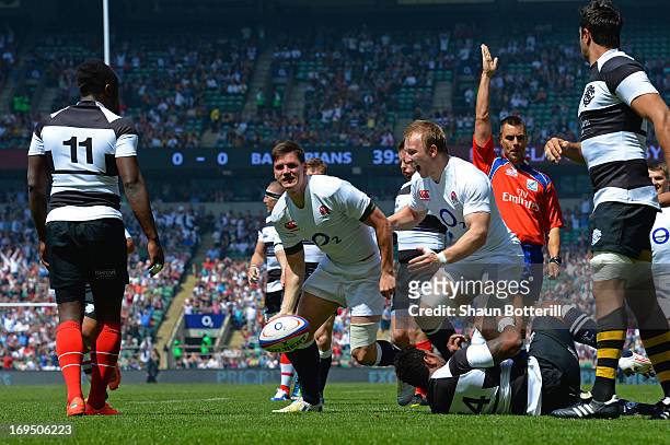 Freddie Burns of England celebrates with teammate Matt Kvesic after scoring the opening try during the rugby union international match between...