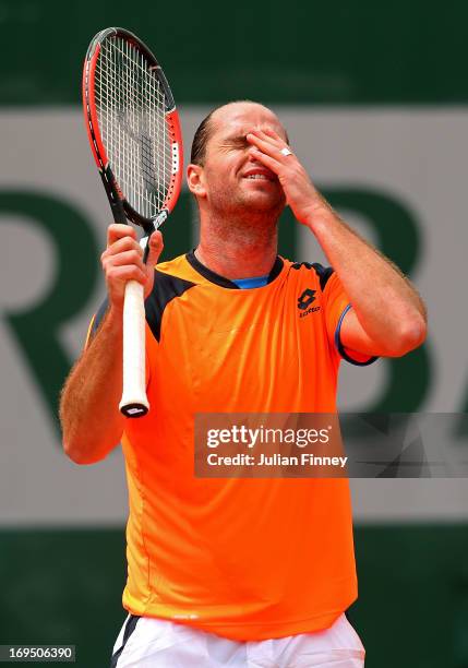 Xavier Malisse of Belgium reacts during his men's singles match against Milos Raonic of Canada on day one of the French Open at Roland Garros on May...