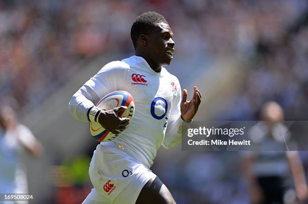 Christian Wade of England runs in his team's fourth try during the rugby union international match between England and The Barbarians at Twickenham...