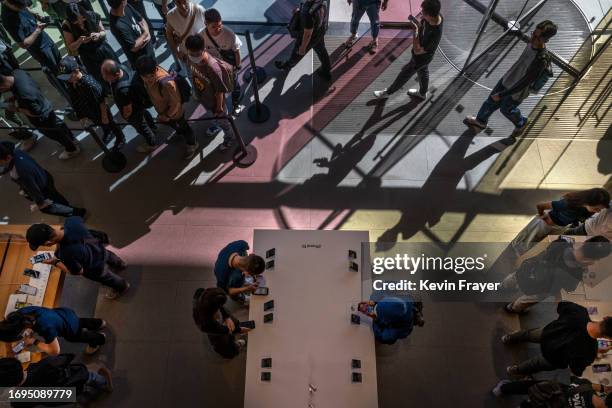 People line up to buy and look at the newly launched iPhone 15 and other Apple products at a flagship store, on September 22, 2023 in Beijing, China....