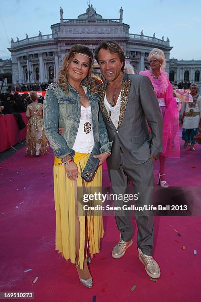 Uwe Kroeger and a friend arrive on the Magenta Carpet at the 2013 Life Ball at City Hall on May 25, 2013 in Vienna, Austria.