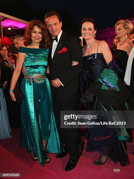 Thomas Koblmueller , Managing Director of Chopard in Austria, and his colleagues Djahana Astanakulova and Silke Sautter arrive on the Magenta Carpet...