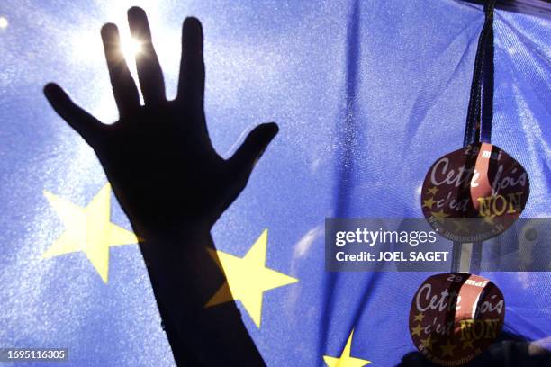The hand's shadow in a EU flag is seen during the last meeting promoting the "no" vote on the 29 May EU constitution referendum, 27 May 2005 in...