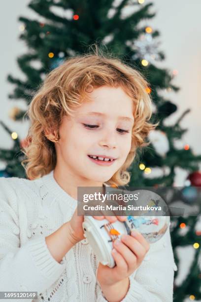 beautiful  girl enjoying  with snow globe. christmas holidays vibe. - funny snow globe stock pictures, royalty-free photos & images