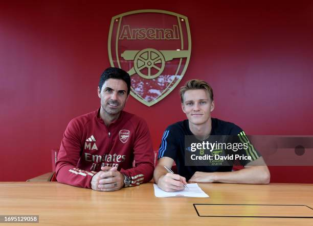 Martin Odegaard signs a new contract with Arsenal with Arsenal Manager Mikel Arteta at the Arsenal Training Ground at London Colney on September 22,...