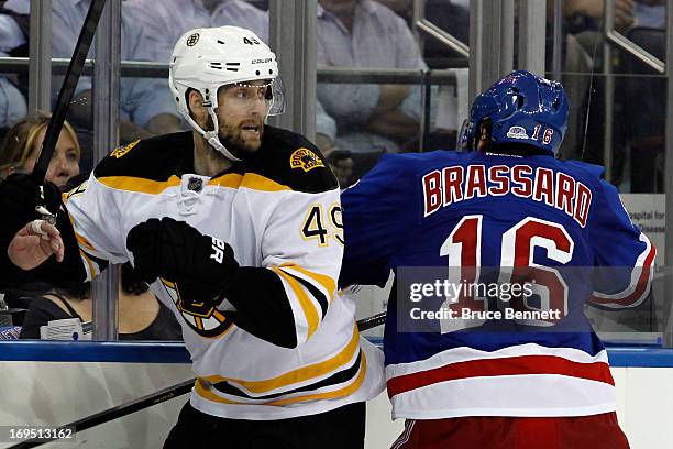 Derick Brassard of the New York Rangers checks Rich Peverley of the Boston Bruins in Game Three of the Eastern Conference Semifinals during the 2013...