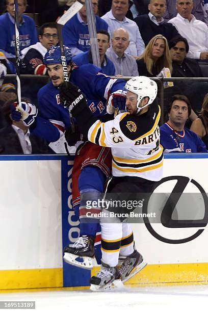 Matt Bartkowski of the Boston Bruins checks Brian Boyle of the New York Rangers in Game Three of the Eastern Conference Semifinals during the 2013...