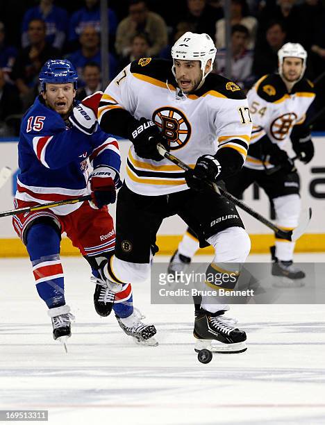 Milan Lucic of the Boston Bruins skates with the puck against the New York Rangers in Game Three of the Eastern Conference Semifinals during the 2013...