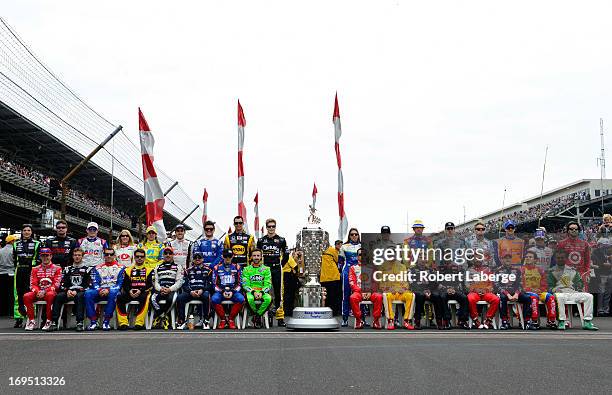 The field of drivers pose for a group photo on the grid during the IZOD IndyCar Series 97th running of the Indianpolis 500 mile race at the...