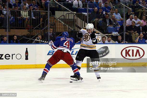 Michael Del Zotto of the New York Rangers checks Brad Marchand of the Boston Bruins in Game Three of the Eastern Conference Semifinals during the...