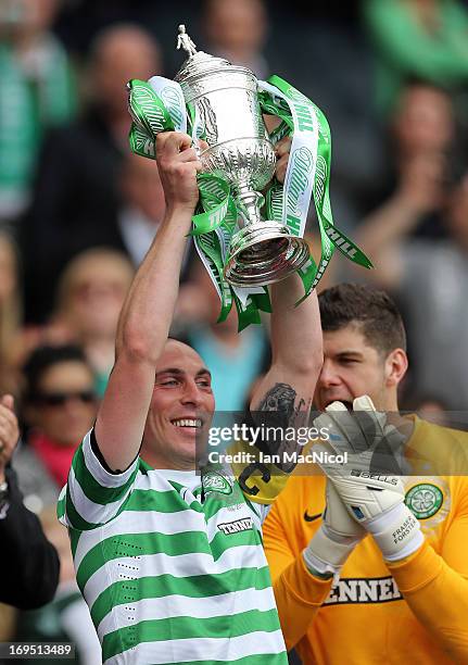 Celtic captain Scott Brown lifts the trophy after defeating Hibernian 3-0 in the William Hill Scottish Cup Final match at Hampden Stadium on May 26,...