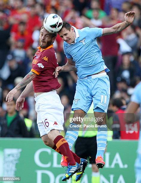 Miroslav Klose of SS Lazio competes for the ball with Daniele De Rossi of AS Roma during the TIM cup final match between AS Roma v SS Lazio at Stadio...